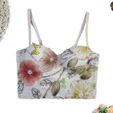 Floral embroidered top with rhinestones on a white background